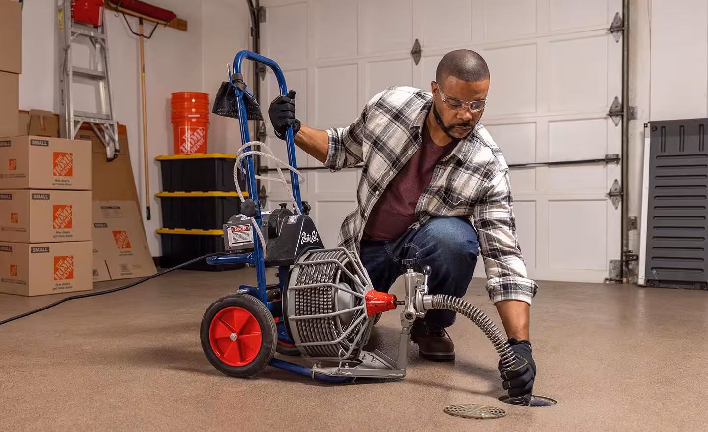 Plumber performing professional drain cleaning